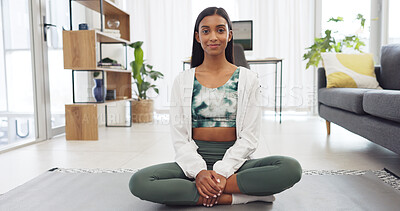 Yoga, fitness and exercise with a woman training with a workout in her home for health and wellness. Healthy, zen and meditation with a young female athlete sitting on a mat in the living room