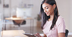 Young happy woman with a digital tablet while relaxing in an office at work. One smiling female student taking pictures to post on social media while sitting alone in a library