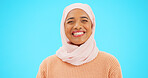 Muslim woman, laugh and happy portrait with a scarf for mockup, advertising or joke. Islamic female model with makeup and hijab laughing for comic emoji, funny meme or fashion on blue background