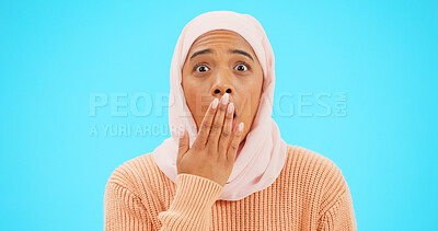 Buy stock photo Surprise, portrait and Muslim woman with announcement, secret and gossip on a blue studio background. Face, Islamic person and model covering her mouth, hijab and shocked with wow, omg and reaction