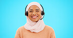 Call center, woman face and isolated on blue background for agent, consultant or muslim telemarketing support. Happy telecom, technical support or communication of hijab person with headset in studio