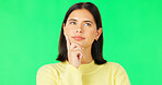 Face, thinking and consider with a woman on a green screen background in studio to decide her options. Idea, mind and contemplating with an attractive young female looking thoughtful on chromakey