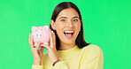 Happy woman, face and money savings on green screen for investment, budget or finance against studio background. Portrait of excited female holding piggybank for coin, profit or investing on mockup