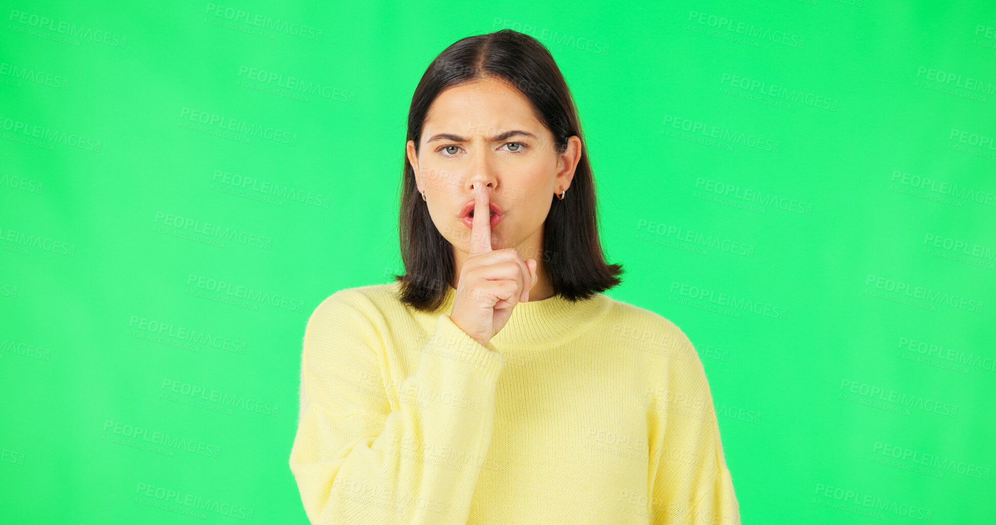 Buy stock photo Whisper, portrait and finger on lips in green screen with woman in studio for privacy, news or secret emoji. Angry, face and gesture for silence, shush and quiet announcement or confidential gossip