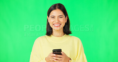 Buy stock photo Woman, portrait and typing with phone on green screen to update social media post, reading notification and chat on studio background. Happy model download mobile app for games, contact or multimedia