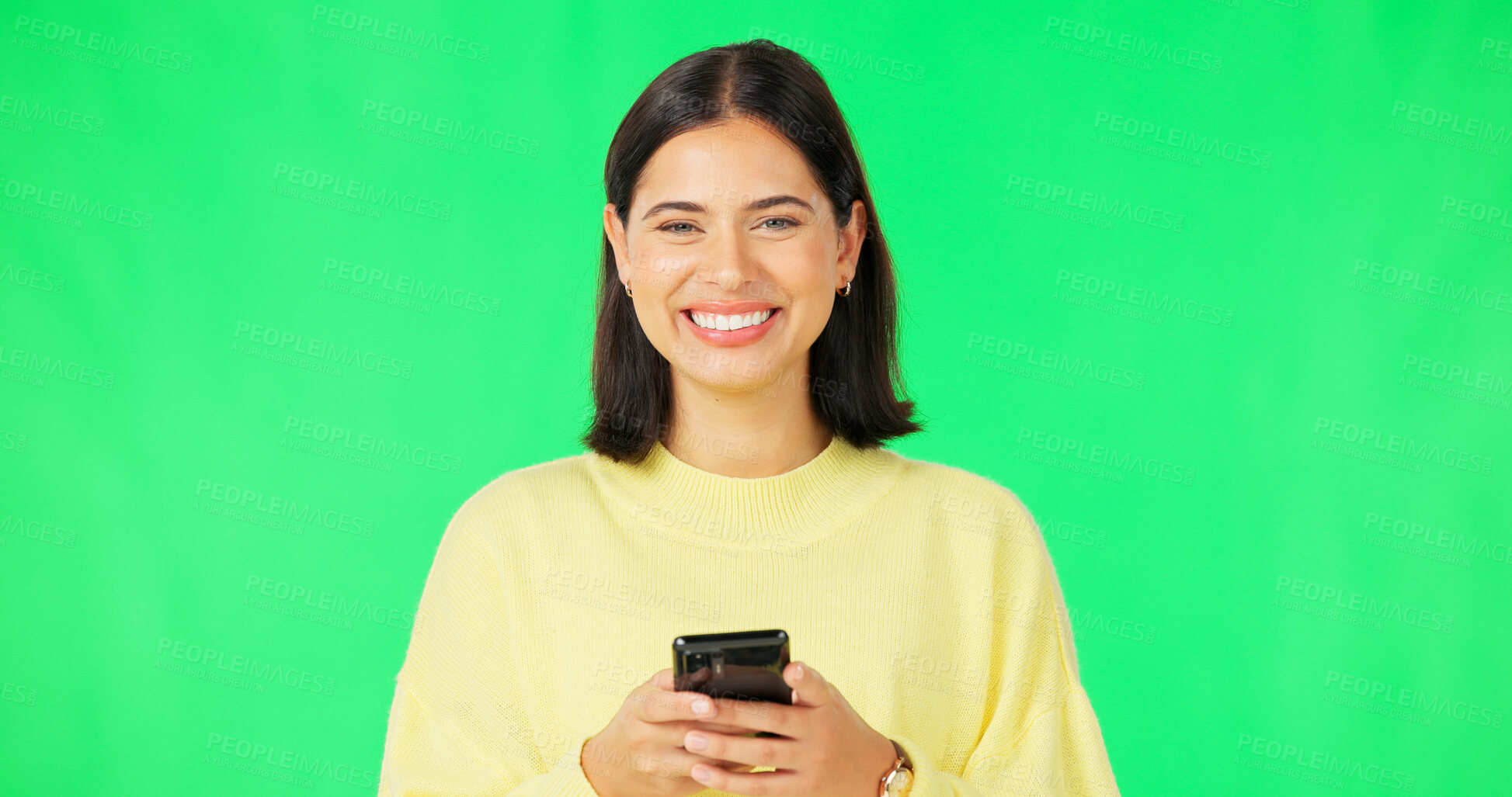 Buy stock photo Woman, portrait and typing with phone on green screen to update social media post, reading notification and chat on studio background. Happy model download mobile app for games, contact or multimedia