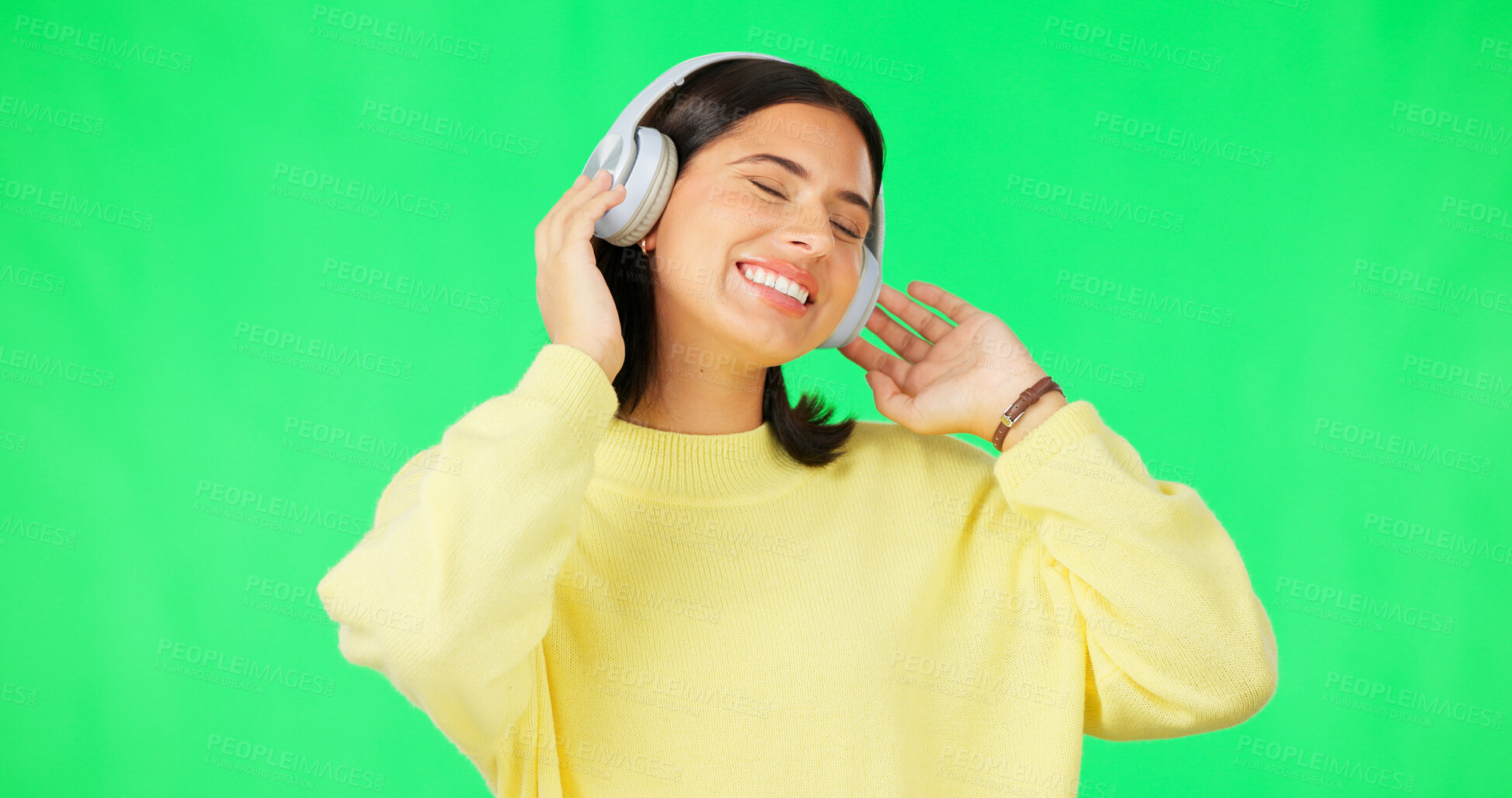 Buy stock photo Green screen, smile and woman with music headphones for podcast, streaming and hearing audio sound on studio background. Happy young model listening to multimedia, subscription and freedom for party