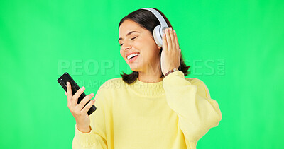 Buy stock photo Green screen, phone and woman with music headphones for online, streaming podcast and hearing audio song on studio background. Happy model listening to mobile multimedia, sound or radio subscription