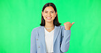 Face, business and woman pointing, green screen and employee against studio background. Portrait, female entrepreneur and consultant with direction, showing space and promotion with happiness and joy