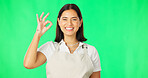 Face, ok hands and happy woman on green screen, background and support of small business startup. Portrait of female model, smile and okay of success, yes and icon of perfect emoji, thank you or sign