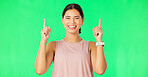 Happy laugh, woman face and pointing up to show promotion and product placement in green screen. Happiness, smile and model gesture to advertising and commercial deal in isolated studio background