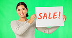 Woman, face and sale sign on green screen, smile and advertising with poster, store promotion and discount. Portrait, billboard and cardboard with text, female with smile on studio background