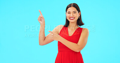 Buy stock photo Portrait, pointing or happy woman in studio for fashion product placement offer on blue background. Smile, sales deal or lady showing logo for advertising space, marketing cosmetics or brand choice