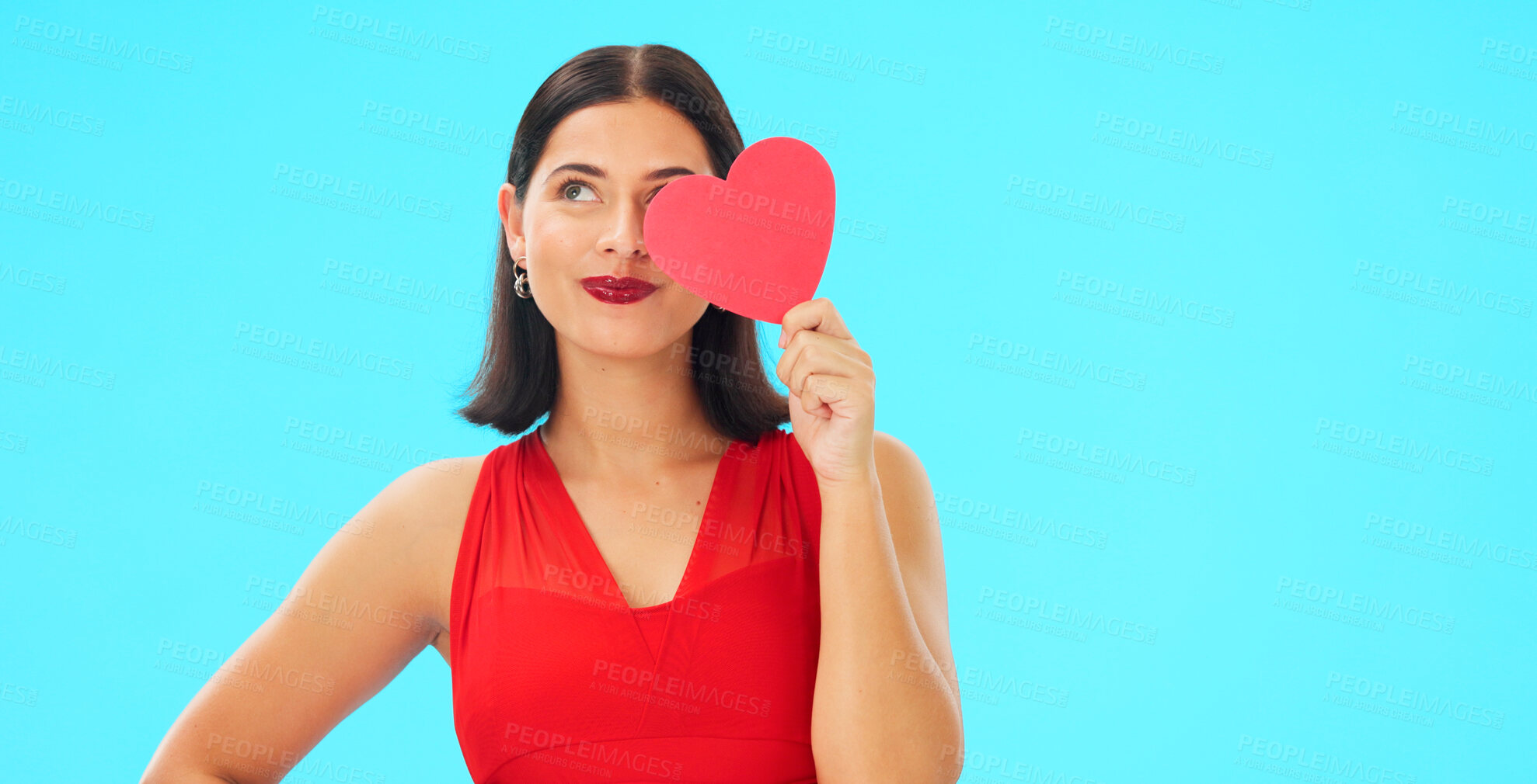 Buy stock photo Thinking, smile and woman with paper heart in studio isolated on a blue background mockup. Idea, romance and model with love sign for anniversary, emoji and smile for valentines day gift or present