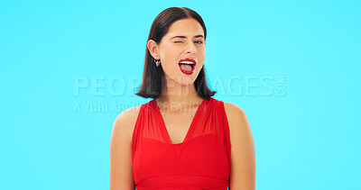 Buy stock photo Happy, woman and winking portrait on a blue background, studio and color backdrop. Flirting, female model and smile for greeting, secret and fun mood in red dress, personality and elegant with mockup
