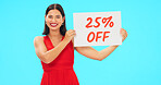 Woman, portrait and sale sign for studio advertising percentage or discount rate on paper or banner. Smile of a happy female on a blue background for fashion promotion deal, savings or deal and offer