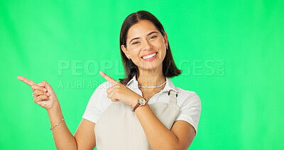 Buy stock photo Woman, person and smile while pointing in studio on green background for mock up of sale, offer or product. Female, server or barista with excitement in news of discount, opportunity or announcement 