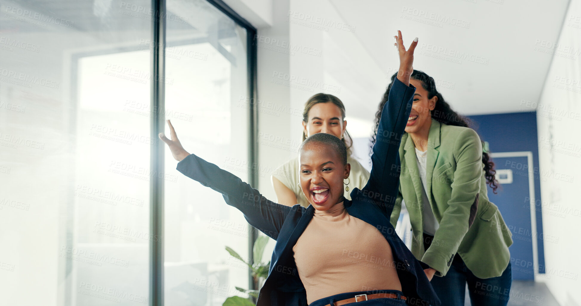 Buy stock photo Office, celebration or business women push chair for happiness, investment growth or startup success in company corridor. Diversity, fun and people with excited face for playing, achievement and win