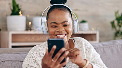 Dance, headphones and black woman on couch, smartphone and streaming music in living room. Dancing, African American female and lady with cellphone, headset and sounds for movement and stress relief