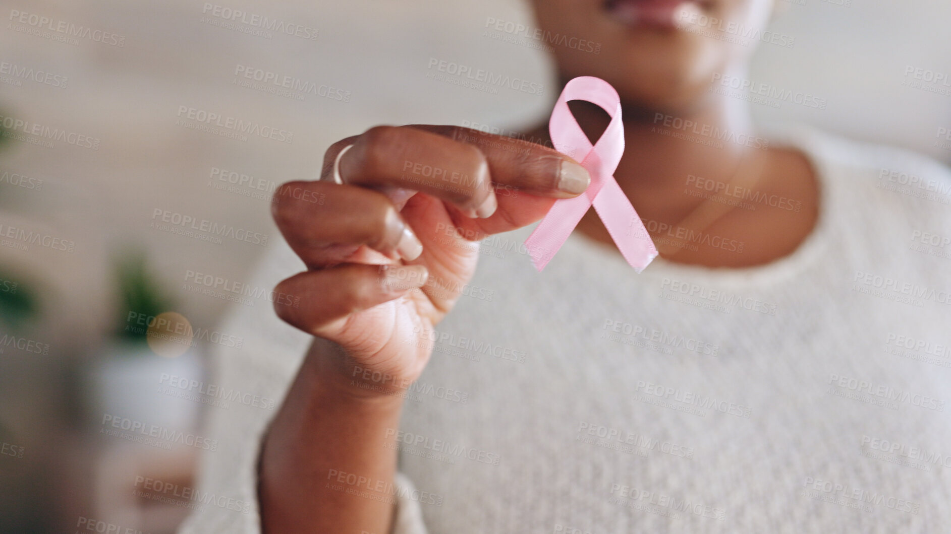 Buy stock photo Hand, person with pink ribbon and breast cancer awareness, health and support with care. Healthcare, campaign with symbol or icon, disease prevention with closeup of bow and wellness with sign