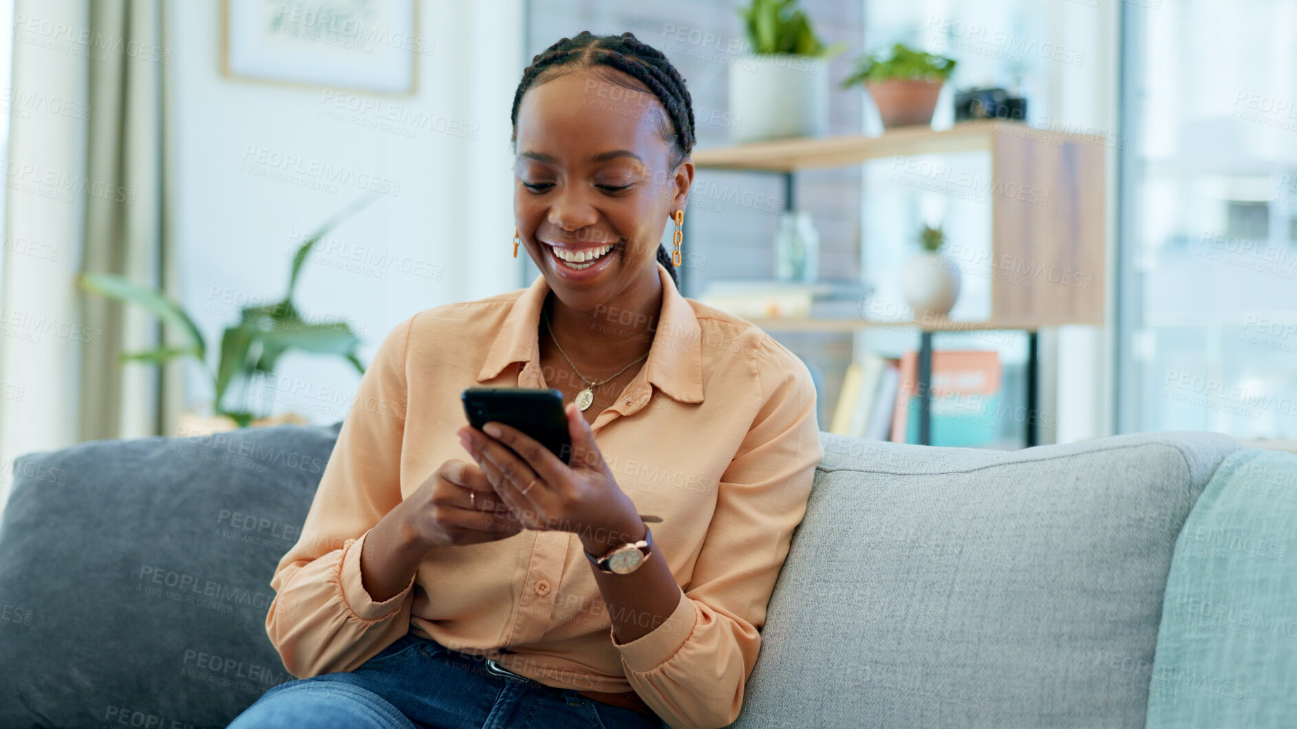 Buy stock photo Happy black woman, phone and social media on sofa in relax, communication or networking at home. African female person smile, laughing or mobile smartphone for funny joke or meme on couch in house