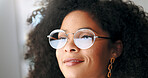 Face portrait of a satisfied business woman reading emails on a computer. Isolated closeup of designer at a workstation. Smiling African American female looking a display or watching content.