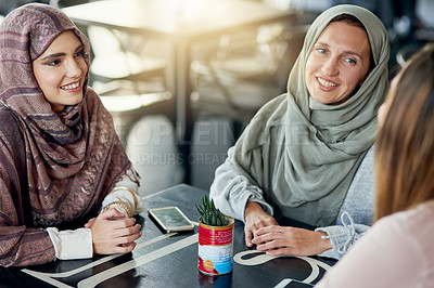 Buy stock photo Friends, relax and Muslim women in coffee shop, bonding and talking together. Cafe, happy and Islamic girls, group or people chatting, conversation and discussion for social meeting in restaurant.