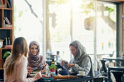 Buy stock photo Friends, happy and Muslim women in restaurant, eating and talking together. Lunch, smile and Islamic girls, group or people chatting, conversation and discussion for social meeting, bonding and food.
