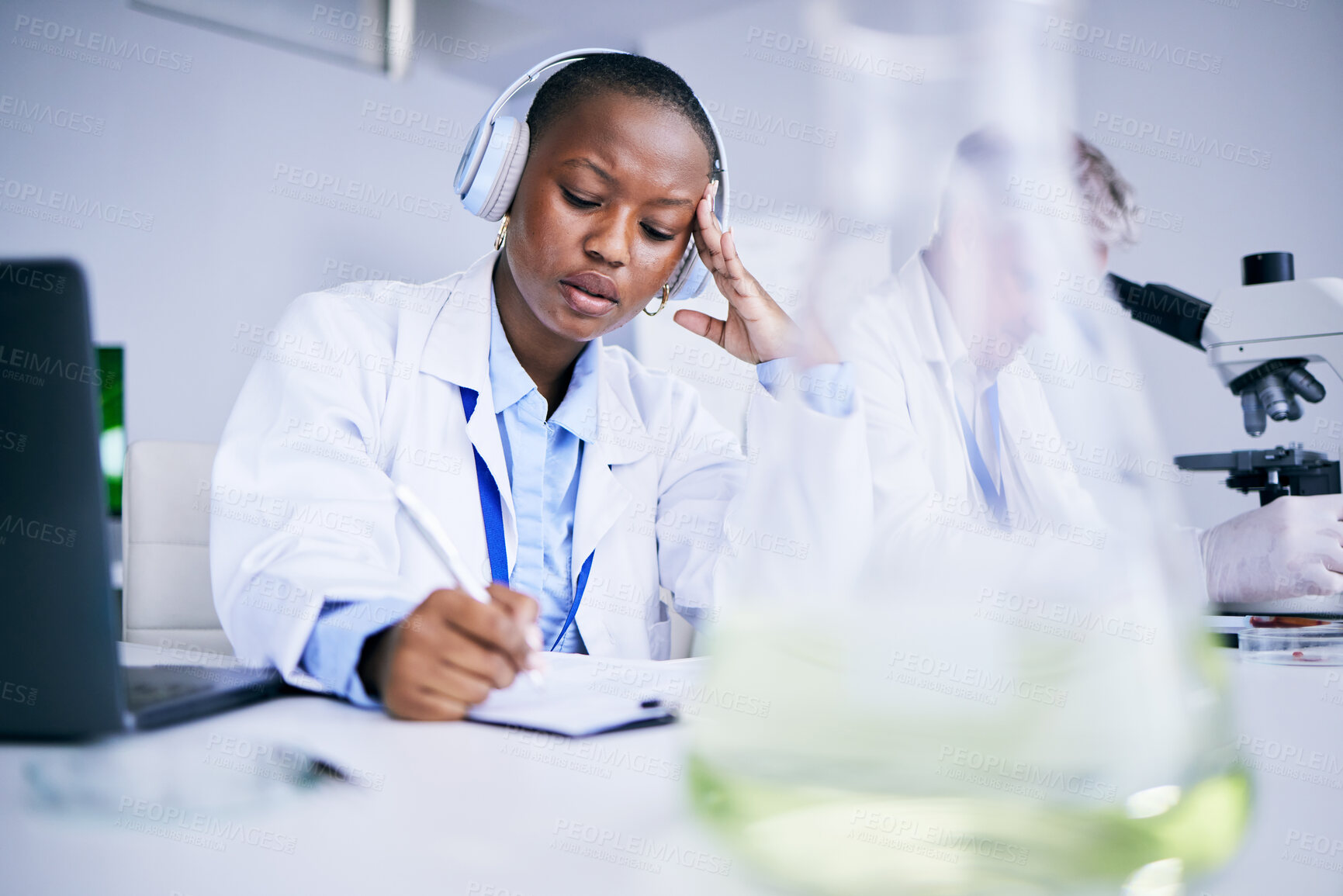 Buy stock photo Science, tired and black woman with a headache, writing or burnout with health issue, overworked and fatigue. Female person, employee or scientist with a migraine, stress or overtime with frustration