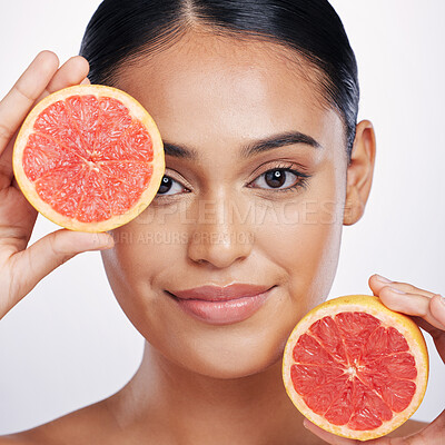 Buy stock photo Woman, portrait and grapefruit for skincare vitamin C, beauty or cosmetics against a white studio background. Face of female person holding fruit for healthy nutrition, natural healthcare or wellness