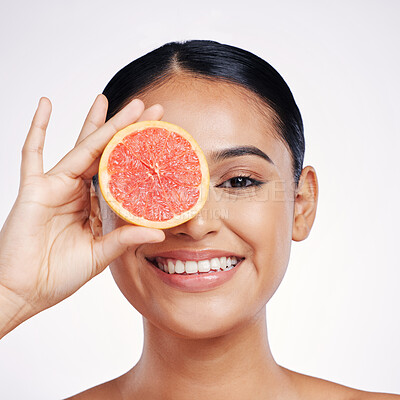 Buy stock photo Happy woman, portrait and grapefruit for natural skincare, beauty or cosmetics against a white studio background. Face of female person smiling with fruit for healthy nutrition, vitamin C or wellness