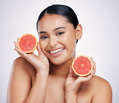 Buy stock photo Happy woman, portrait and grapefruit for skincare vitamin C, beauty or cosmetics against a white studio background. Female person smile with fruit in healthy nutrition, natural healthcare or facial