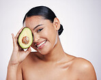 Happy woman, portrait and avocado for natural skincare, beauty or cosmetics against a white studio background. Female person smiling with fruit or vegetable for healthy nutrition, fibre or wellness