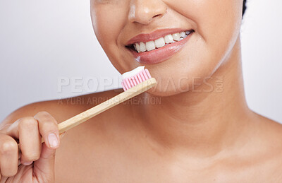 Buy stock photo Teeth, smile and woman with toothpaste on toothbrush, dental and oral hygiene isolated on studio background. Female model, happy with mouth care and cleaning, fresh breath with health and closeup