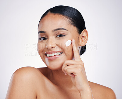 Buy stock photo Woman in portrait, cream on face and beauty with skincare, smile and moisturizer isolated on studio background. Happy female model apply lotion, dermatology and cosmetic product with skin glow