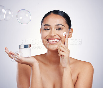 Buy stock photo Beauty cream, face and skin of woman in studio for glow, dermatology and cosmetics. Portrait of happy female model with product container in hand with bubbles, skincare and health on white background