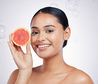 Buy stock photo Face, grapefruit and beauty portrait of woman in studio for skin glow, dermatology or natural cosmetics. Model person with fruit and bubbles for detox, healthy diet and skincare on a white background