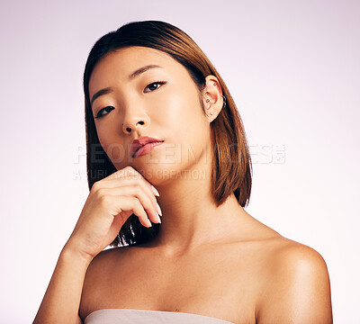 Buy stock photo Serious, face and skincare of Asian woman in studio isolated on a white background. Natural beauty, portrait and female model with makeup, cosmetics and facial treatment, aesthetic and skin wellness.