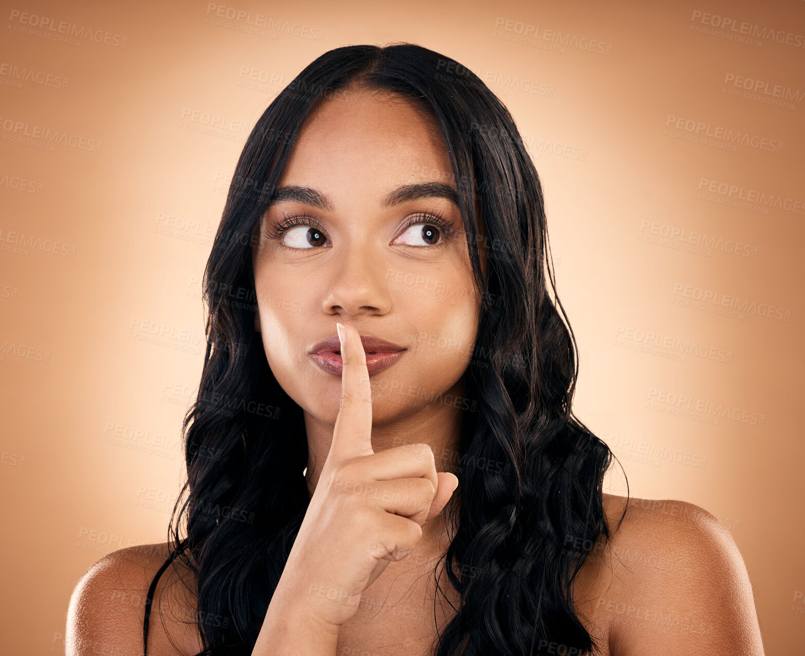 Buy stock photo Beauty, secret and woman with hand on face in studio for makeup, cosmetics or dermatology care. Spa, salon or luxury skincare or facial, cosmetic treatment or fingers on lips on brown background