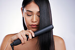 Hair care, electric straightener and woman with long hairstyle, luxury salon treatment and white background in Brazil. Beauty, healthy haircut and relax, latino model and flat iron on studio backdrop