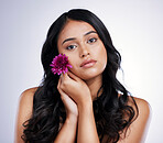 Hair care, beauty and portrait of woman with flower, natural makeup and luxury salon treatment on white background. Nature, hairstyle and flowers, latino model with floral haircare on studio backdrop