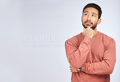 Buy stock photo Man, thinking and idea mockup in studio or planning, decision and choice with white background. Asian male, model and curious face with doubt, questions or confused guy try to remember with space

