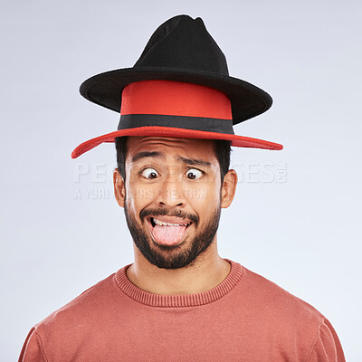 Buy stock photo Silly, hats and goofy man in a studio with a crazy, funny and comic face expression or pose. Comedy, happy and Mexican male person with fun head accessories and humor isolated by a white background.