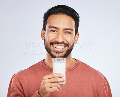 Buy stock photo Man with milk, drink and health with nutrition, calcium and vitamins with vanilla shake isolated on studio background. Dairy product in glass, beverage and male person smile, healthy and portrait