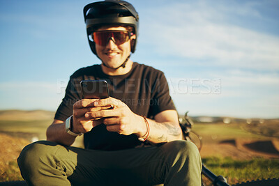 Buy stock photo Biker, outdoor and man with a smartphone, typing and connection for social media, network and communication. Male person, cyclist or guy with a cellphone, mobile app and texting with sms and chatting