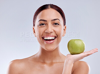Buy stock photo Apple, portrait or happy woman in studio eating on white background for healthy nutrition or clean diet. Smile, hand or excited girl showing natural organic green fruits for wellness or digestion 