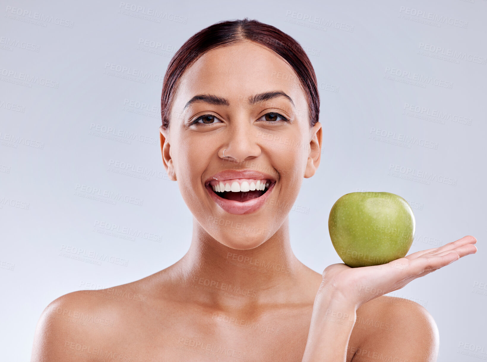 Buy stock photo Apple, portrait or happy woman in studio eating on white background for healthy nutrition or clean diet. Smile, hand or excited girl showing natural organic green fruits for wellness or digestion 