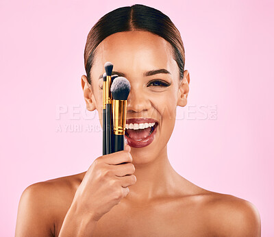 Buy stock photo Happy woman, portrait smile and brushes for makeup, beauty or cosmetics against a pink studio background. Excited female person model with cosmetic tools or equipment for grooming or facial treatment