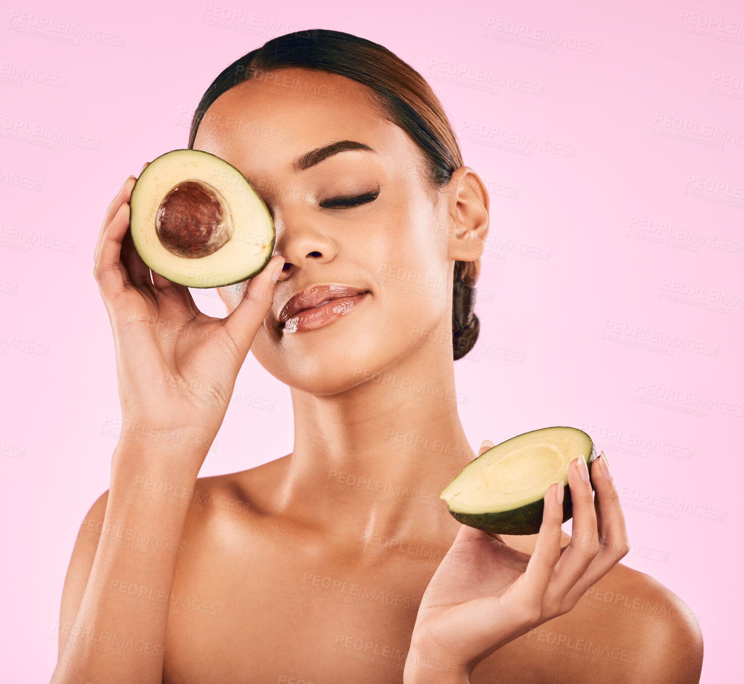 Buy stock photo Woman, avocado and nutrition in natural beauty or skincare cosmetics against a pink studio background. Face of calm female person or model in relax with vegetable for healthy wellness, fiber and diet