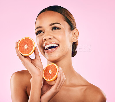 Buy stock photo Happy woman, smile and grapefruit for skincare nutrition or natural vitamin C against a pink studio background. Face of female person smiling with organic fruit for healthy diet, fiber or wellness